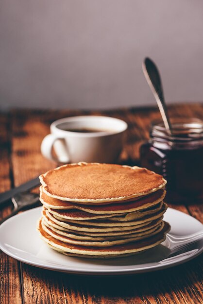 Stack of pancakes on white plate