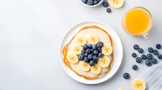 A stack of pancakes with bananas and blueberries on top