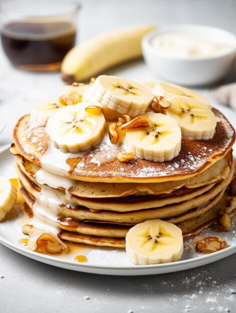 a stack of pancakes with bananas and syrup on them.