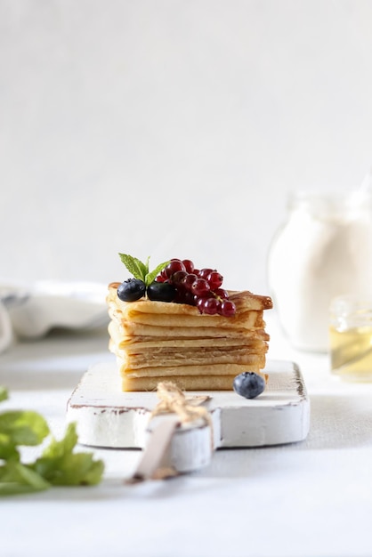 A stack of pancakes with berries on top