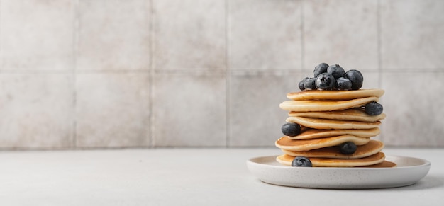 A stack of pancakes with blueberries on top