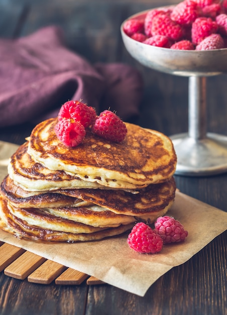 Stack of pancakes with fresh raspberries