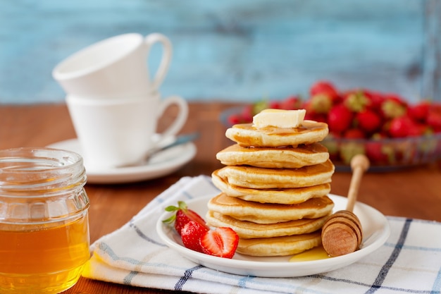 Stack of pancakes with honey syrup