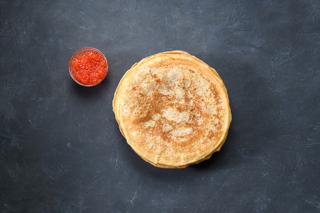 Stack of pancakes with red caviar, top view