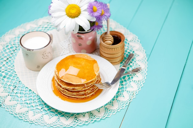 Stack of pancakes on wooden background