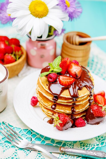 Stack of pancakes on wooden background