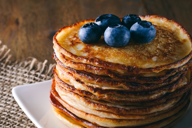 Stack of pancakes on wooden table