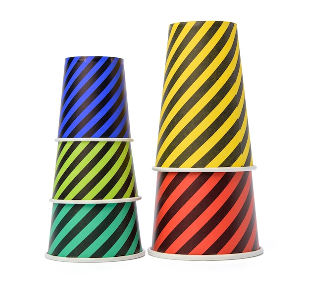 Photo stack of paper disposable striped cups isolated on white background, zero waste