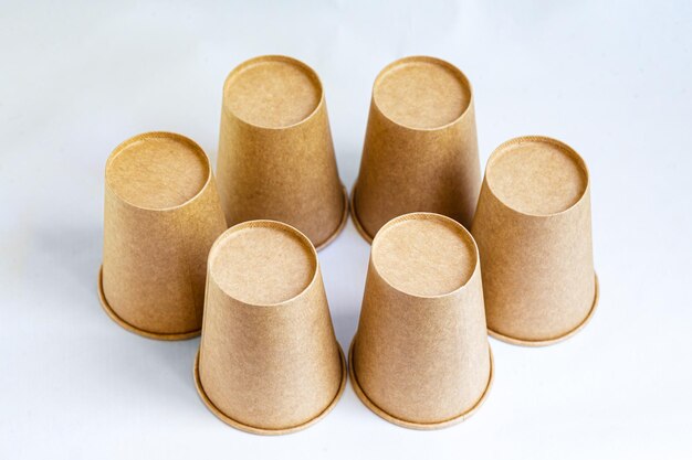 Photo stack of paper mugs six disposable paper cups made of cardboard kraft paper