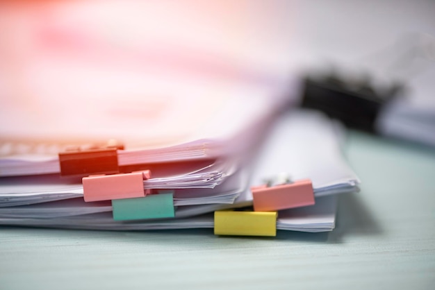 Photo stack of paper with binder clips on table