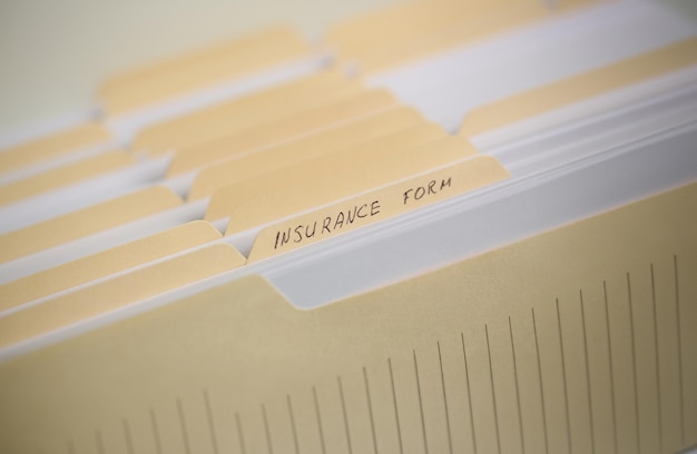 A stack of papers in filing cabinet with inscription