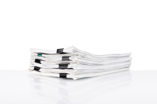 A stack of papers in the office on a white table White isolated background