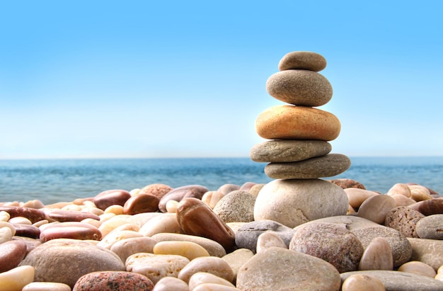 Stack of pebble stones on white