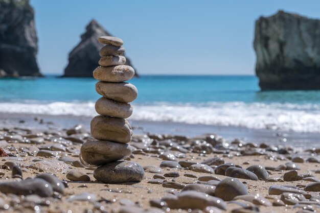 Stack of pebbles on beach against clear sky