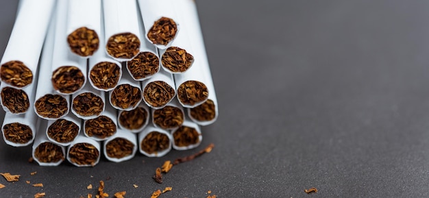 Stack pile cigarette or tobacco on black background