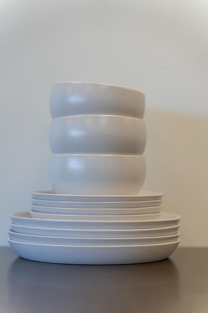 A stack pile of white chinaware on a table