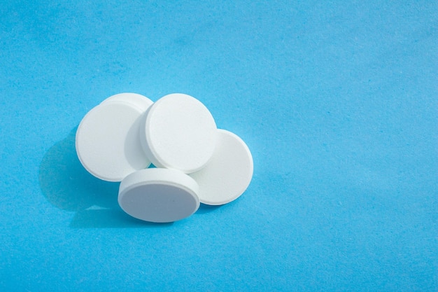 A stack of pills on a blue background