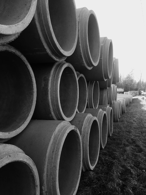 Photo stack on pipes on field against clear sky