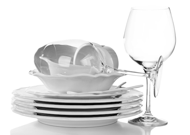 Stack of plates cups and wineglasses on white background