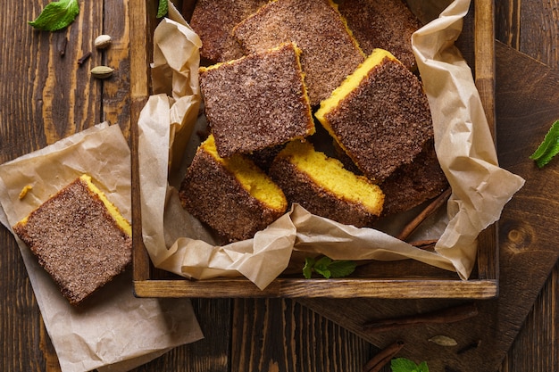 A stack of pumpkin blondy with sugar and cinnamon on wooden