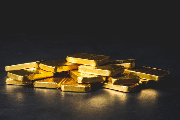 Photo stack of pure gold bars on black background