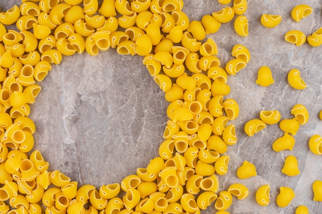 A stack of raw pipe pasta, on the marble