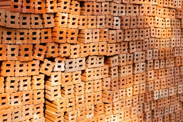 Stack of red bricks orange clay bricks