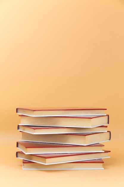 Stack of red cover books on a yellow background