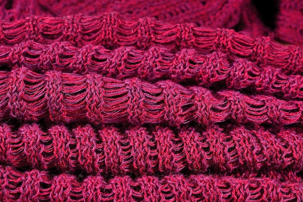 Stack of red crumpled melange openwork knitted fabric