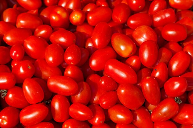 Stack of red plum tomatoes a market stall