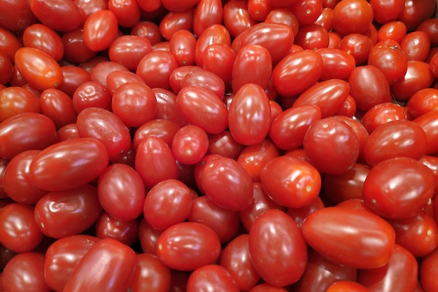 Stack of red plum tomatoes a market stall