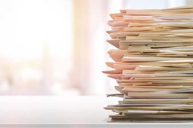 Stack of report paper documents in office