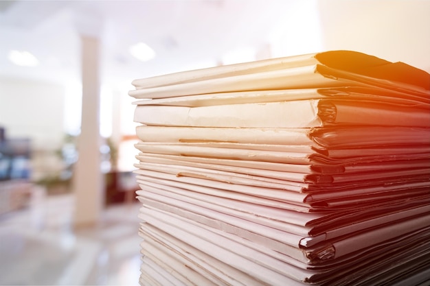 Stack of report paper documents in office