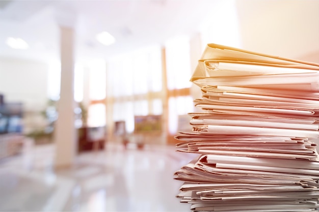 Stack of report paper documents in office