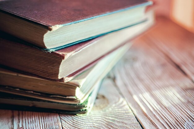 Stack of retro books on wooden table