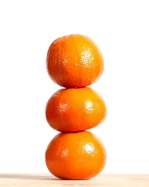 Stack of ripe oranges fruit on wooden table 