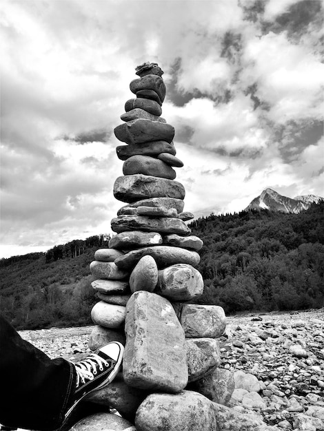 Stack of rock on landscape against sky