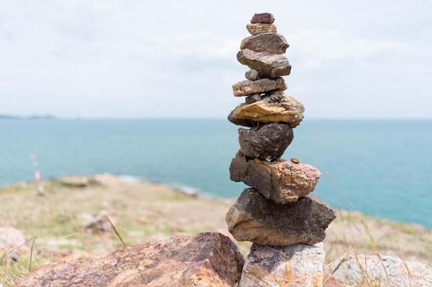 Stack of rocks against sea and sky