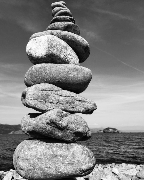 Photo stack on rocks against sea