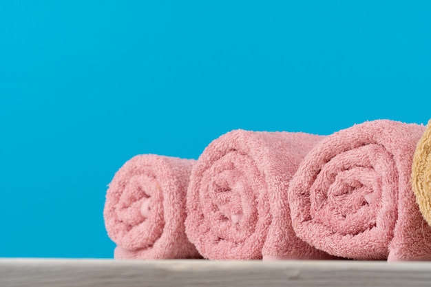 Photo stack of rolled towels on a wooden table