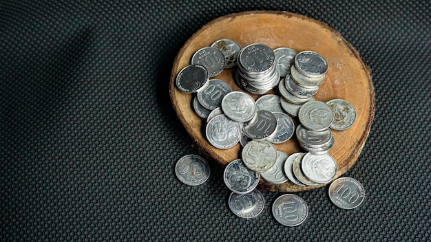 Stack of rupiah coins rupiah Indonesian money isolated in black background