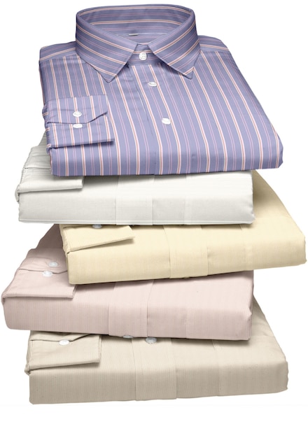 A stack of shirts with a pink shirt on top