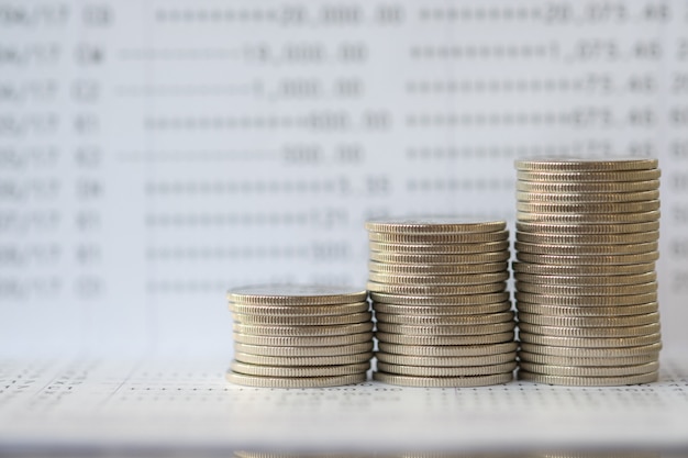 Stack of silver coins on bank passbook.