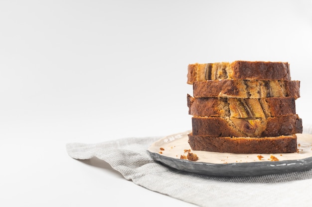 Photo stack of sliced fresh banana bread slices on white background