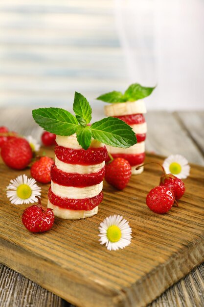 Stack of sliced fruits on table close up