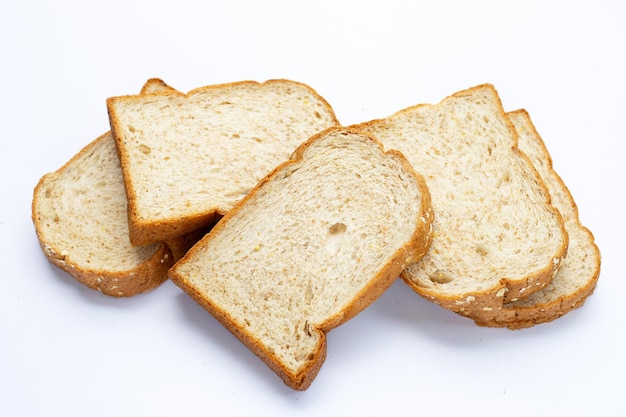 Stack of sliced wholegrain bread on white background