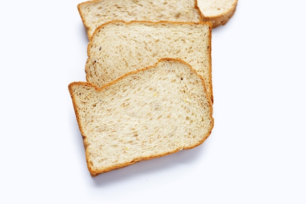 Photo stack of sliced wholegrain bread on white background