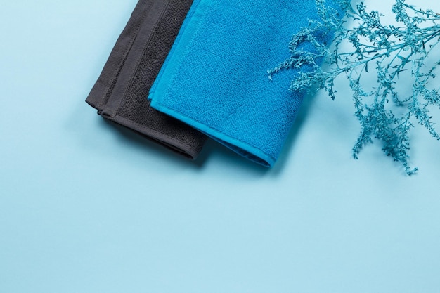 Photo stack of soft terry towels on blue background