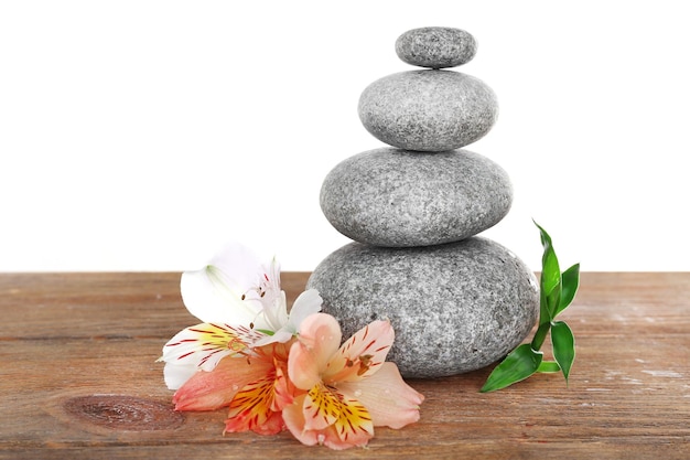 Stack of spa stones with flower isolated on white