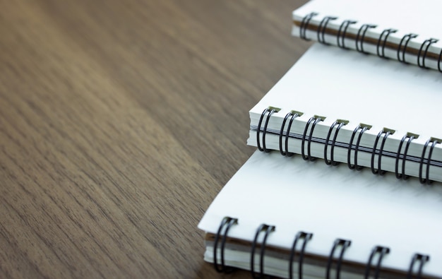 Stack of spiral notebook on wood table